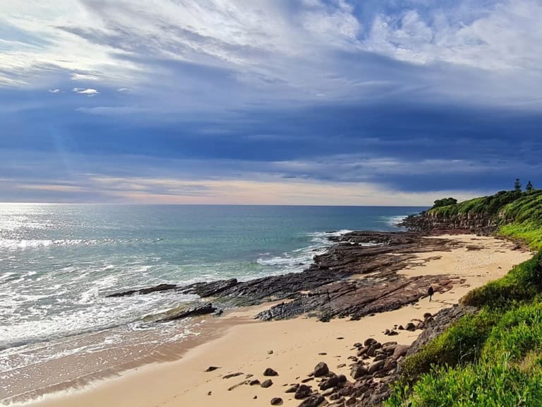 a lone person walks on a beach in Mimosa Rocks National Park